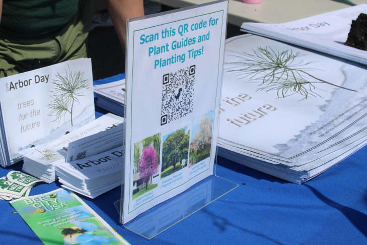 Arbor Day sapling giveaway table supplies, bookmarks, posters, planting guides